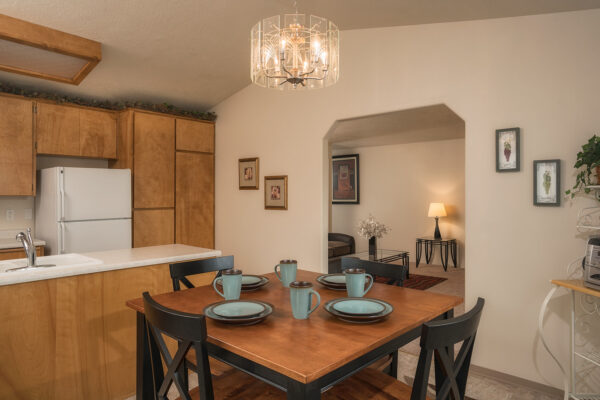 Dining table with teal dishes in kitchen