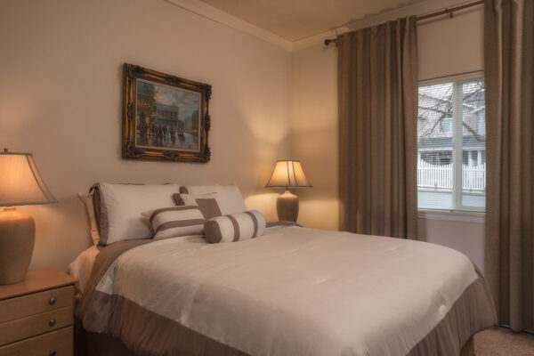Cozy neutral bedroom with lamps and window