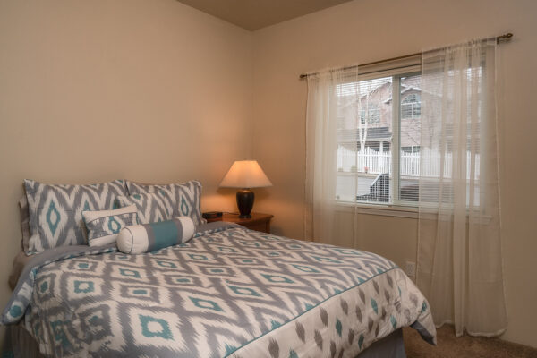 Cozy bedroom with patterned bedding and lamp