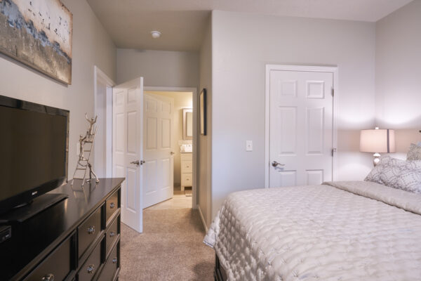 Cozy neutral bedroom with bed and dresser